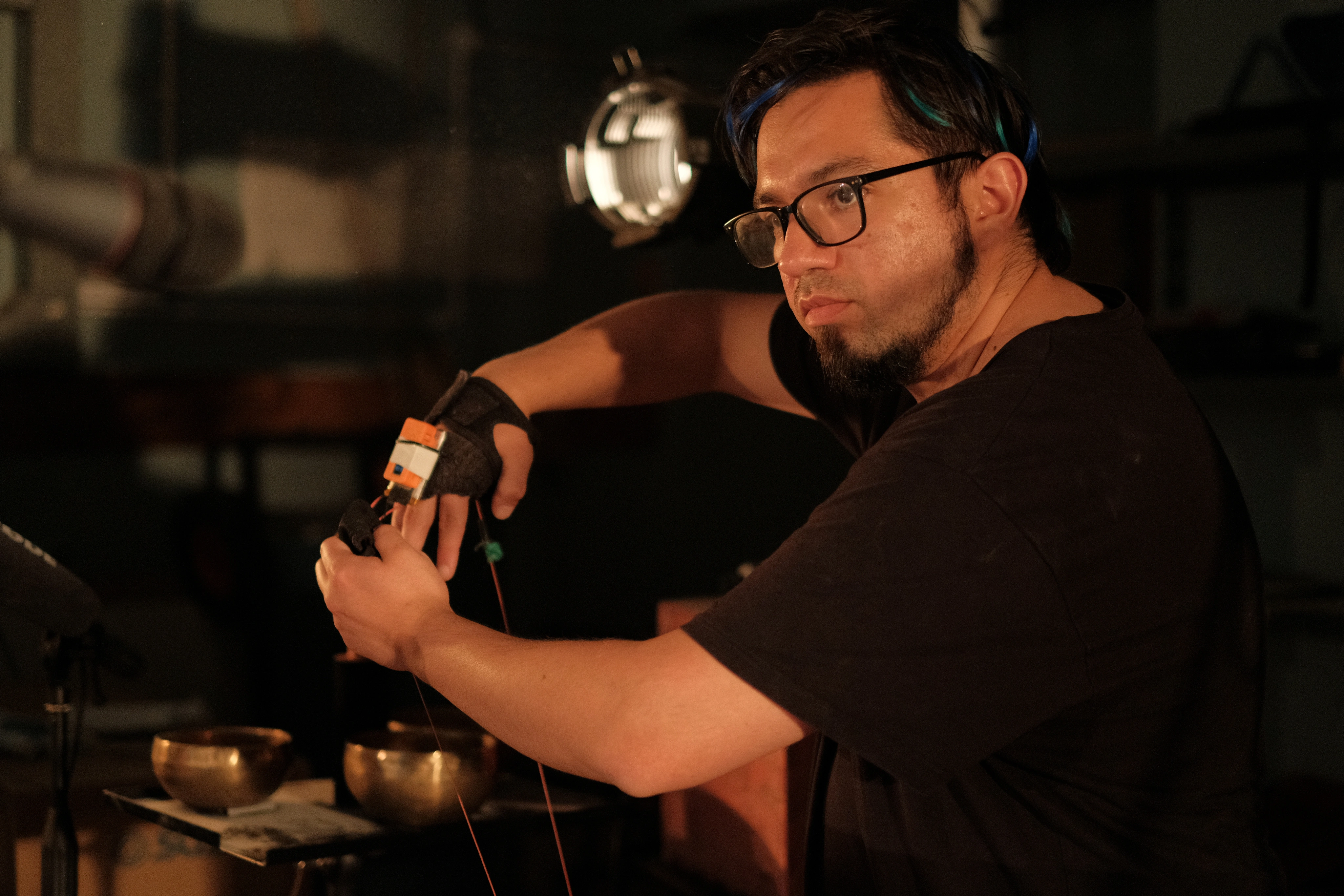 Xavier wearing custom glove controllers during a performance of Megalith.